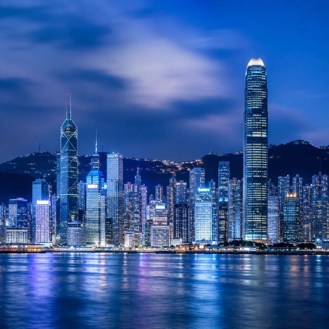 Hong Kong skyline across Victoria Harbour at blue hour